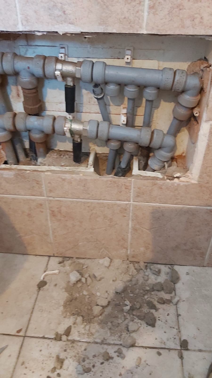 Hidden manifold behind wall tiles during renovation work