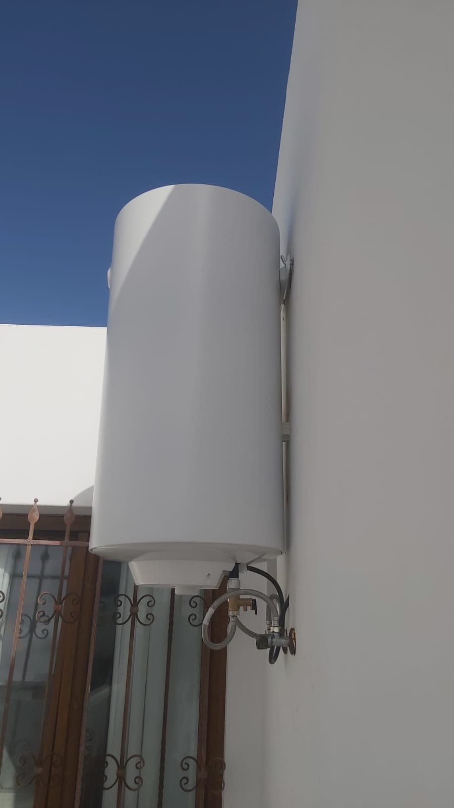 Electric water heater wall installation with valves