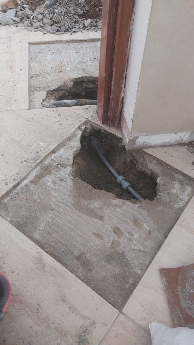 Excavated floor with pipe exposed during leak repair